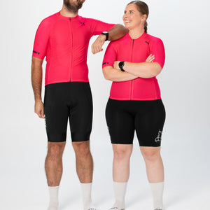 Man and Woman wearing Magenta Cycling Jersey and Black Bib Shorts Front