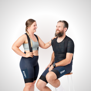 Man and woman in slate grey cargo bib shorts front
